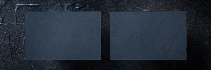 Wall Mural - Black business card mockup panorama on a black slate, front and back, a template for design presentation, thick cardboard