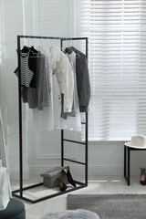 Sticker - Rack with stylish women's clothes in dressing room. Interior design