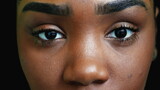 A black teen girl closing eyes in meditation person opening eye macro close-up