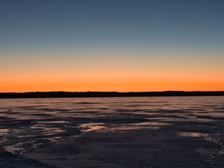 Wall Mural - lake in ice in spring against the backdrop of a red sunset