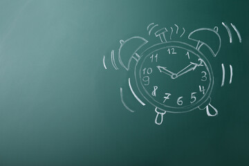 Drawn alarm clock on green chalkboard, space for text. School time