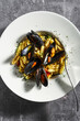pasta Sardinian gnocchetti with mussels, tomato and parsley. on the table