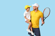 © Pixel-Shot - Little boy and his trainer with tennis racket on blue background