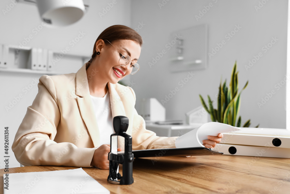 Female notary public working in office