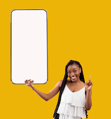 Poster - Great App. Cheerful African American Female Holding Big Blank Smartphone