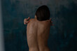 © Cavan Images - Back view of woman embracing back by hands at blu deep studio