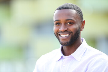 Wall Mural - Handsome happy man with black skin looks at you