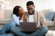 © Prostock-studio - Portrait of African American couple using laptop at home