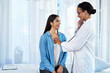 © Chanelle M/peopleimages.com - Strong set of lungs you have there. Shot of a young doctor examining her patient with a stethoscope.