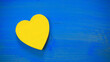 Red wooden Yellow heart shape on blue background. Ukraine Love Concept.