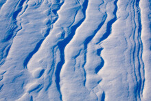Light And Shadow Across Waves Of Snow
