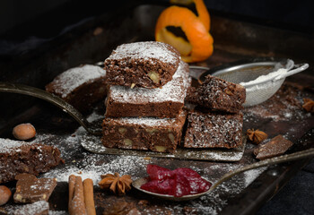 Canvas Print - baked square pieces of chocolate brownie sprinkled with powdered sugar on the table