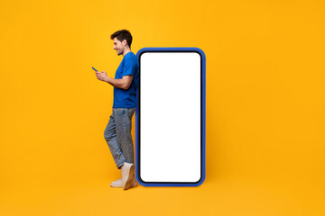 Wall Mural - Man leaning on white blank smartphone screen, using cellphone