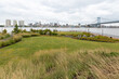 Looking out over the grassy field and landscape architecture at RCA Pier Park, an urban revitalization project on the Delaware River waterfront in Camden, New Jersey, USA