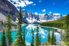 Famous Moraine Lake In Banff National Park, Canadian Rockies, Canada. Sunny Summer Day With Amazing Blue Sky. Majestic Mountains In The Background. Clear Turquoise Blue Water.