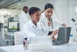 © Nicholas Felix/peopleimages.com - Improving lives one collaboration at a time. Shot of two young scientists using a laptop in a laboratory.