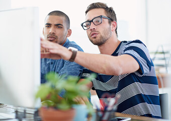 Poster - Creative collaborators. Shot of two male designers working together at a computer.