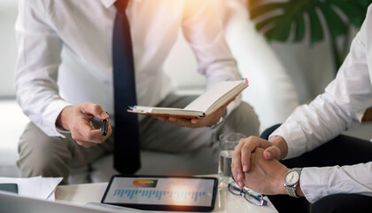 Businessman advisor, two business people talking, planning analyze investment and marketing on tablet in office.