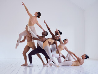 Sticker - Pulling together to create beauty. Shot of a group of ballet dancers practicing a routine in a dance studio.