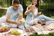 © hetmanstock2 - Happy family have a picnic in park near the lake