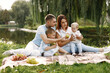 © hetmanstock2 - Happy family have a picnic in park near the lake