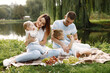 © hetmanstock2 - Happy family have a picnic in park near the lake