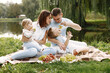 © hetmanstock2 - Happy family have a picnic in park near the lake
