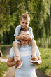 © hetmanstock2 - Portrair of a boy sitting on his father's shoulders and closing his eyes