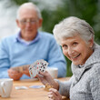 © Alexandra W/peopleimages.com - Helping the time pass with card games. Two seniors playing cards together.