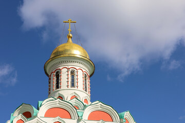 Wall Mural - Golden dome of the Christian temple with a cross against the blue sky and white clouds. Orthodox church, Kazan Cathedral in Moscow