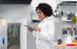 © Syda Productions - cooking, culinary and people concept - happy smiling female chef in white jacket with tablet pc computer over restaurant kitchen background