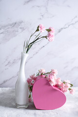 Wall Mural - pink carnations in a white vase and a gift in a pink box, gift valentine's day,