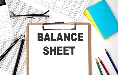 Poster - Clipboard with text BALANCE SHEET and keyboard and chart on the white background.