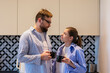 © Елена Бабанова - Young couple two friends man woman in casual clothes in the kitchen at home relaxing in the morning