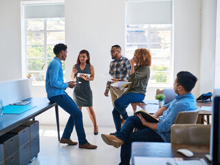 Poster - Creative discussions done as one. Shot of a team of young entrepreneurs having a discussion in a modern office.