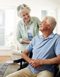 © Anne/peopleimages.com - Caring for each other in their winter years. Shot of a smiling senior man in a wheelchair and his wife at home.