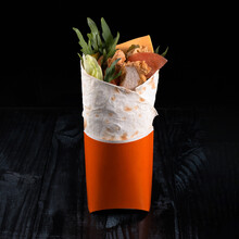 A Delicious Doner Donair Kebab Wrap With Meat, Lettuce, Tomato, Red Onion And Sauce. Doner In Red Box On A Dark Background