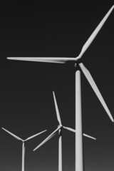 Wall Mural - close up of white wind turbines on black background