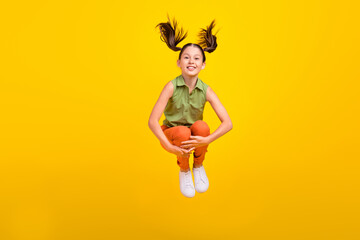 Sticker - Photo of sweet carefree student girl wear green shirt smiling jumping high isolated yellow color background