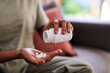 © Meeko Media - A close up of hands pouring out pills from a bottle