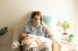 © oksix - Woman drink tea or coffee during process of breastfeeding of newborn baby