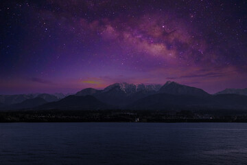 Wall Mural - Landscape with Milky Way. Night sky with stars on the mountain