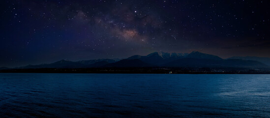 Wall Mural - Landscape with Milky Way. Night sky with stars on the mountain