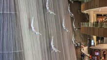 Giant Fountain With Flying Sculpture Of An Diver Timelapse In Dubai Mall.