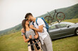 © BGStock72 - Couple of hikers with backpacks starting a walk through the fields