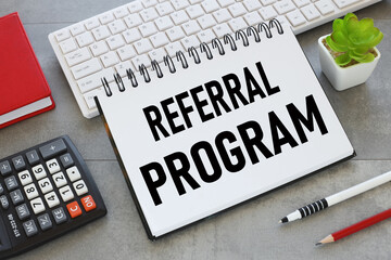 notepad with text on white keyboard Referral Program