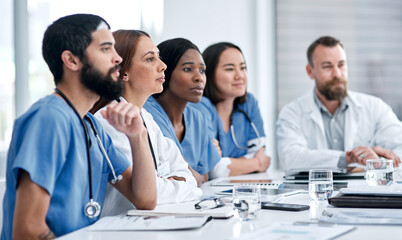 Aufkleber - Working together to plan a patients care. Shot of a doctor sitting alongside her colleagues during a meeting in a hospital boardroom.