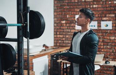 Aufkleber - Just making sure everythings in good state. Cropped shot of a handsome young male fitness instructor inspecting exercise equipment while working in a gym.
