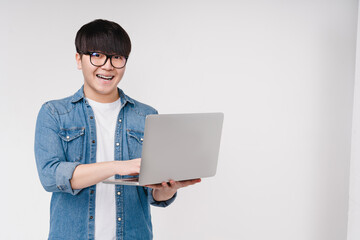 Happy asian korean young coder programmer student man freelancer hacker working remotely on laptop, doing online shopping, e-learning on distance, browsing, e-commerce isolated on white background