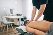 © Daniel Gonzalez/Stocksy - Physiotherapist massaging back of patient in clinic